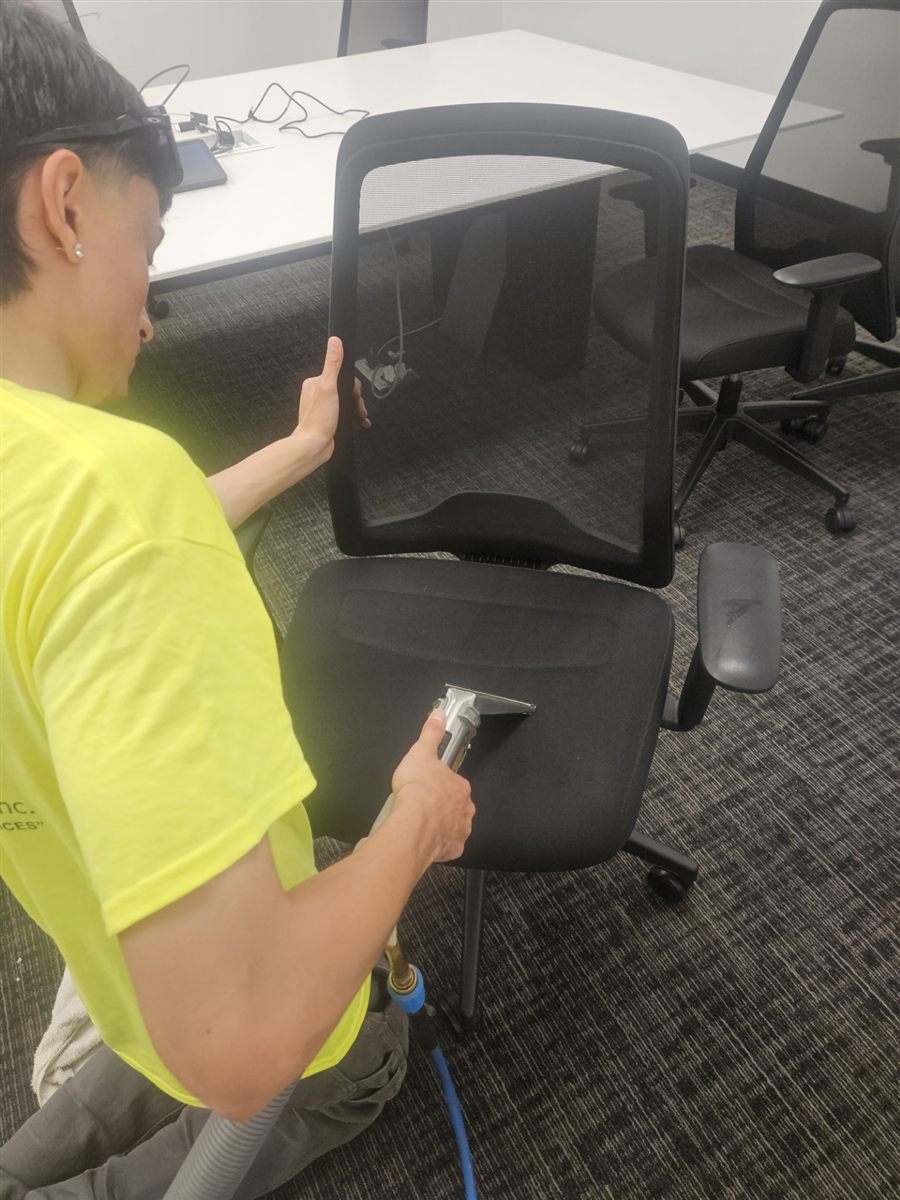 Done Just Right technician deep cleaning an office chair with hot water extraction